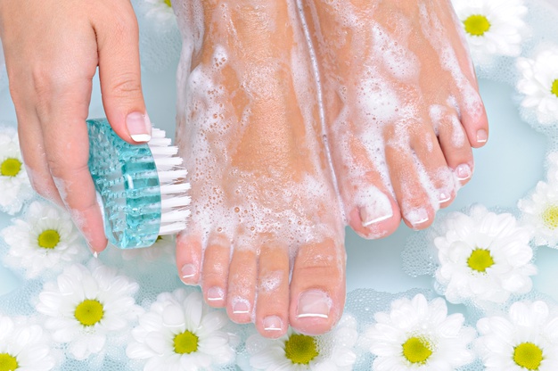 cleaning feet with soap and water 