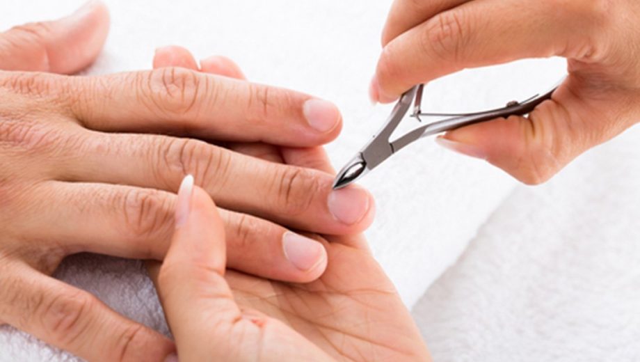 manicurist-cutting-off-cuticle